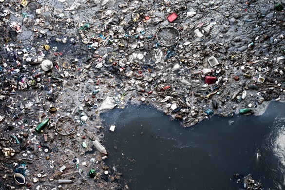 Aerial shot of the ocean filled with tons of plastic waste