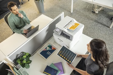 Two men sitting by computers